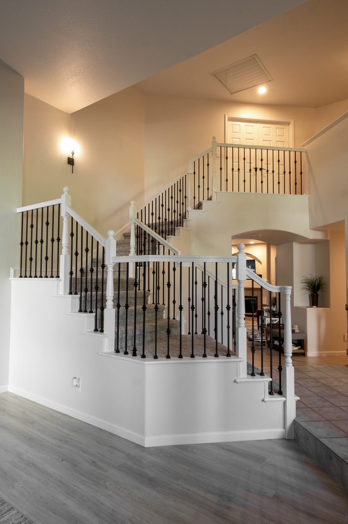 Full staircase refresh with new iron balusters and refinished, repainted railing and posts — Northern California