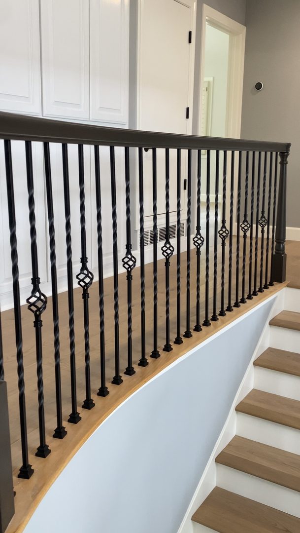 Iron baluster upgrade with fully refinished railing and newel posts — Roseville area