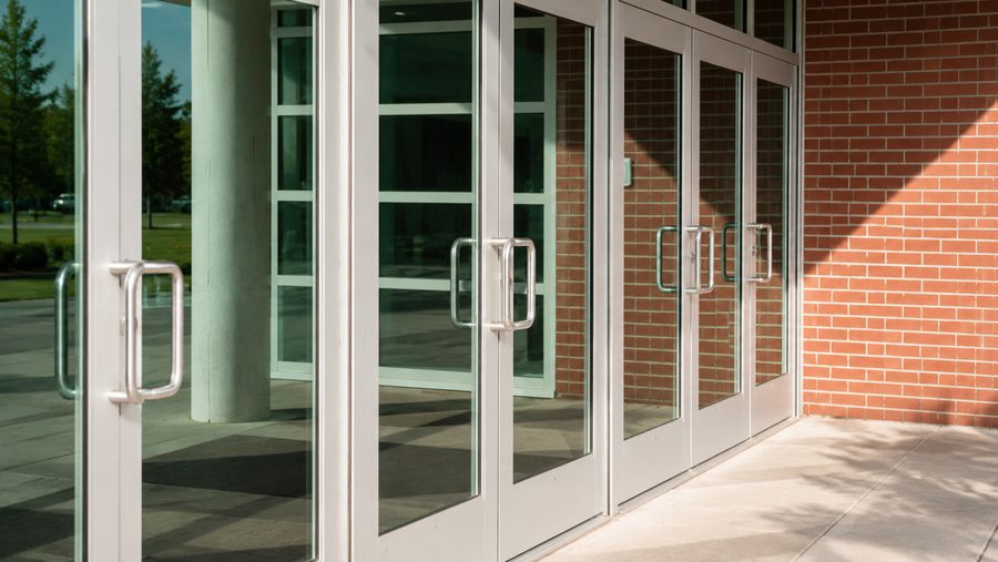 Commercial glass entry doors on a brick building
