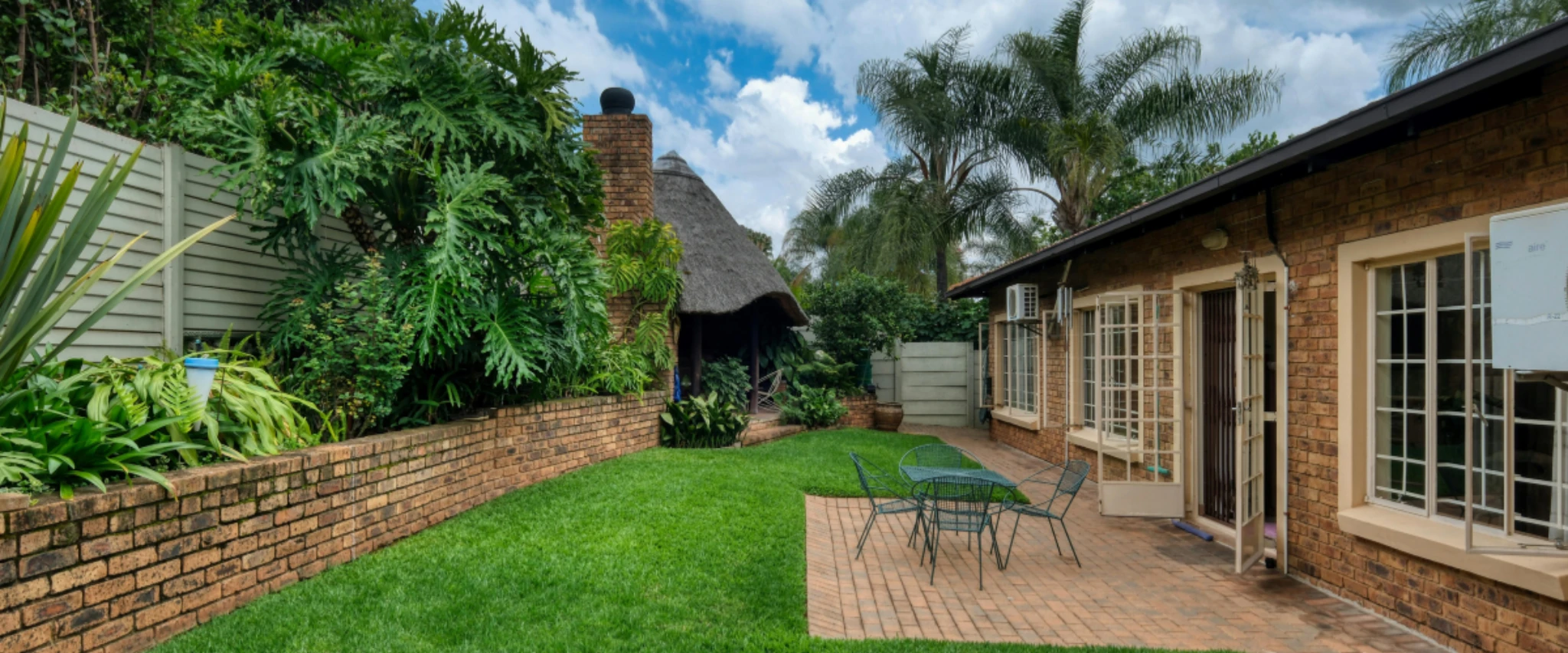 Wide view of lush green grass lawn with natural texture.