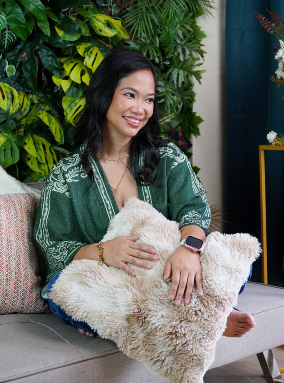 Annikka smiling, hugging a cushion