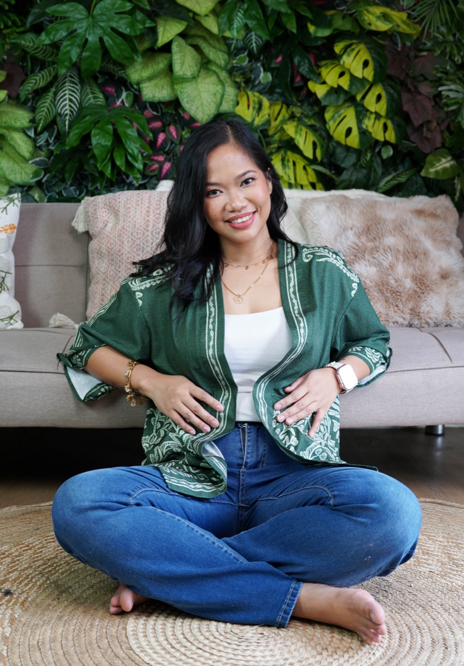 Annikka Aborro, smiling, seated cross-legged