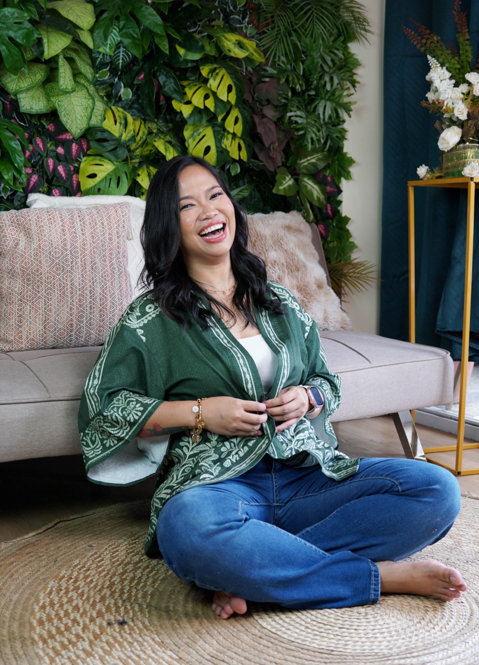 Annikka laughing, seated on the floor