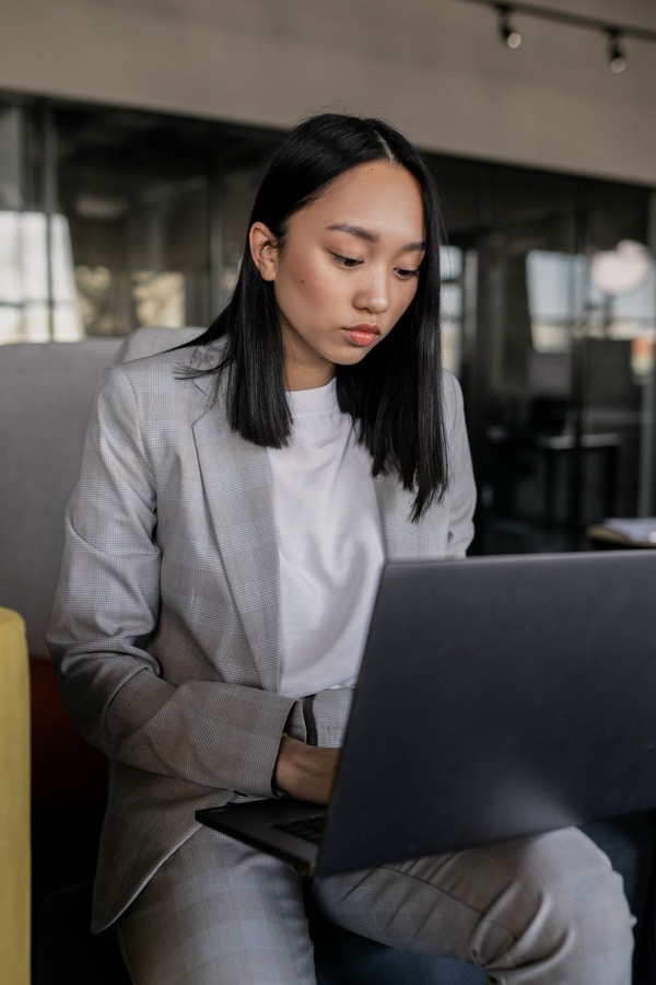 A professional working on her laptop in an office