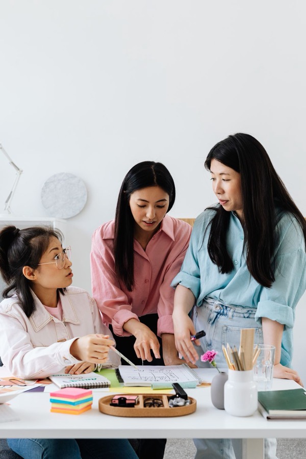 Three women planning together at a table