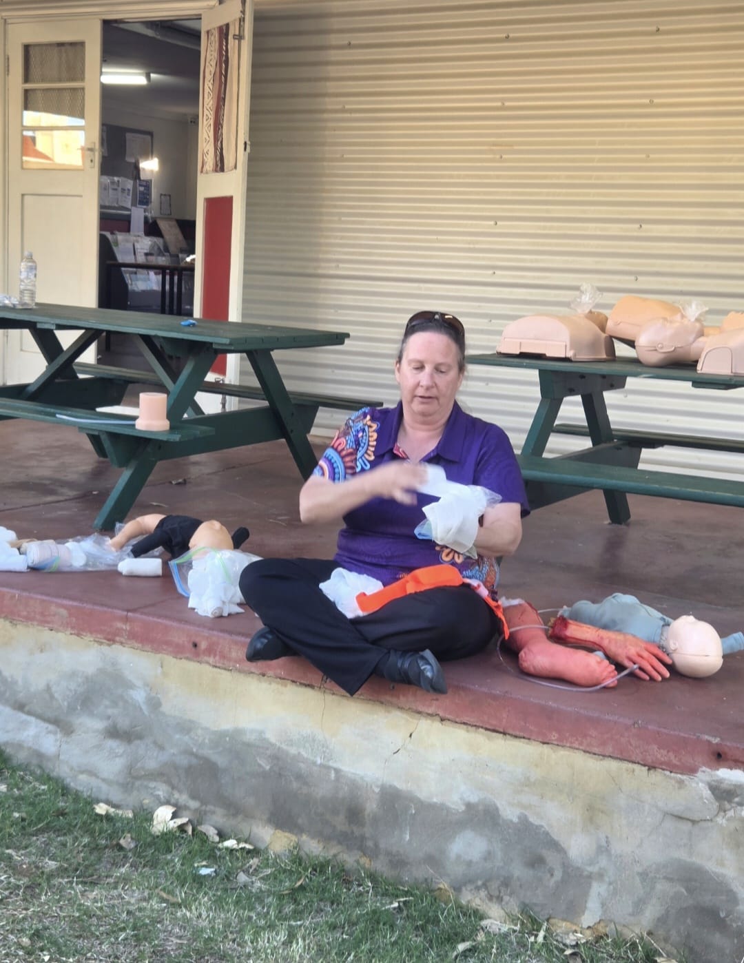 Britt Brennan teaching a REACHAU first aid course to a group of participants