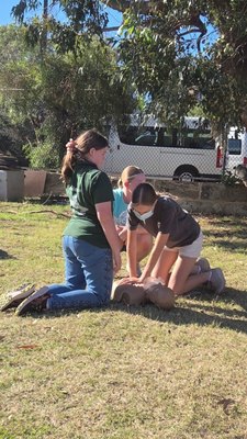 Britt Brennan demonstrating CPR to participants at a REACHAU HLTAID011 first aid course
