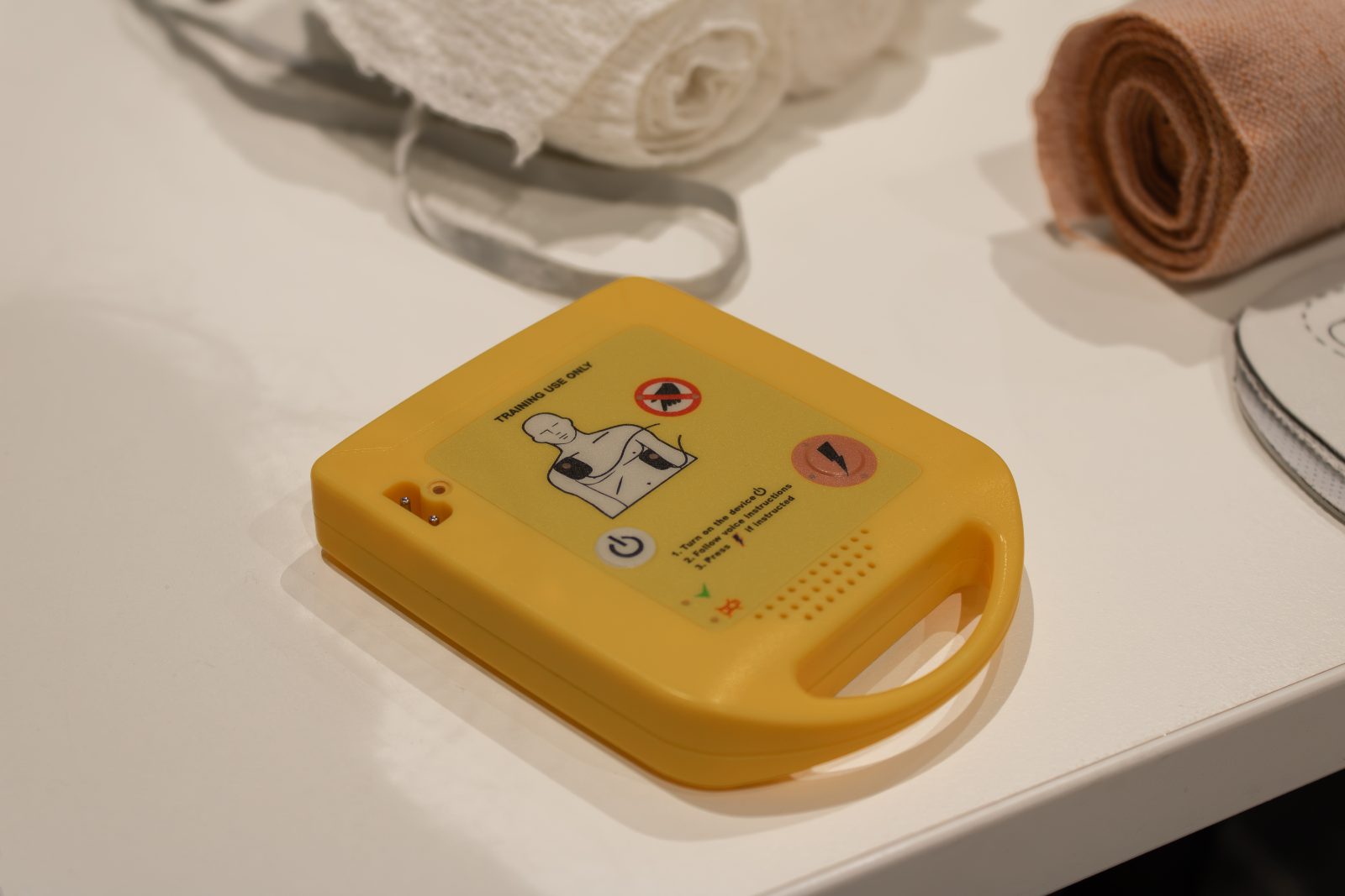 AED training unit and bandages ready for a workplace first aid drill