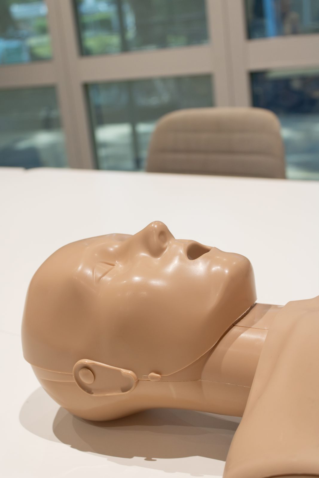 CPR manikin head in a head tilt and chin lift position to open the airway