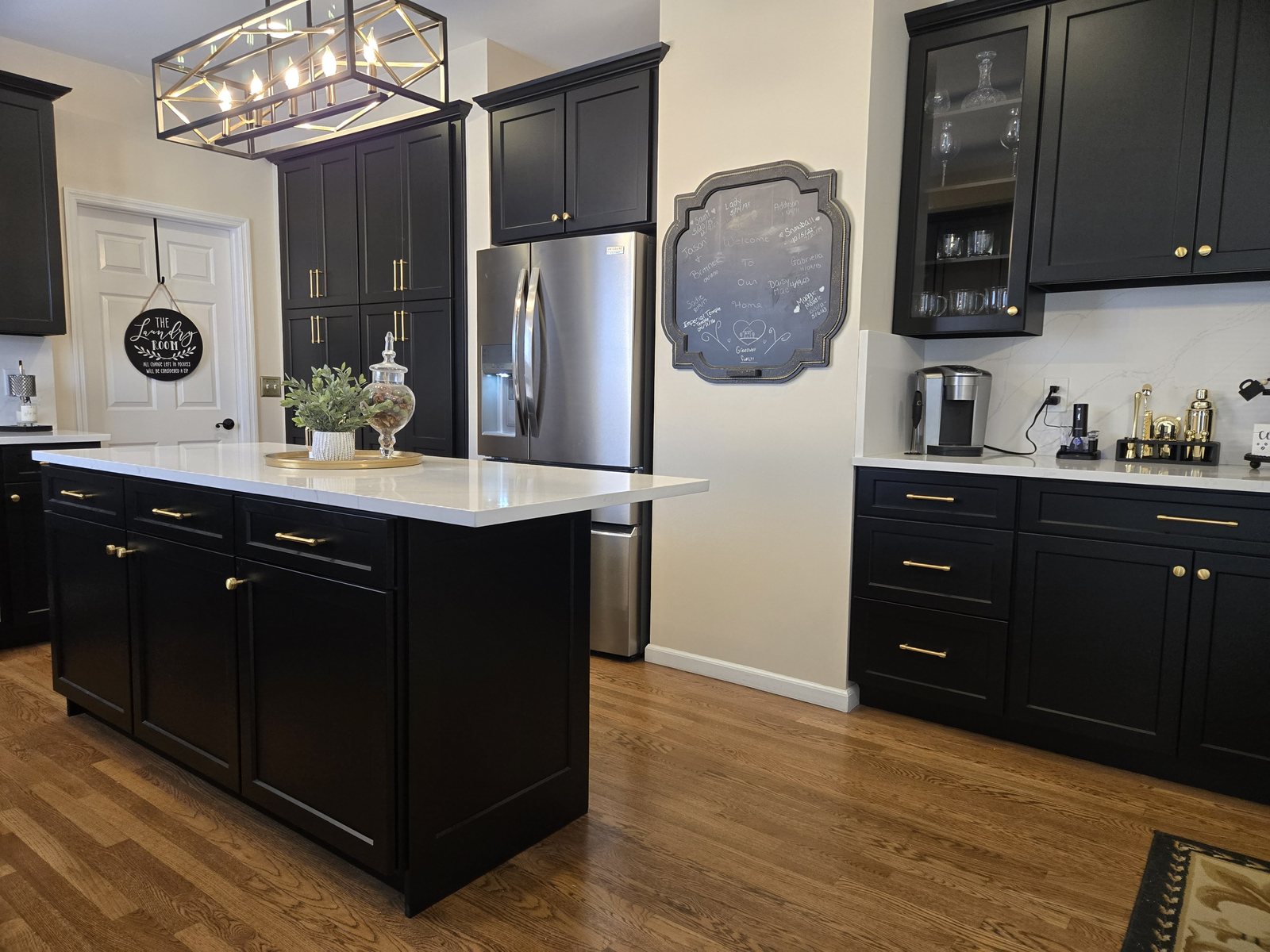 Kitchen with black shaker cabinets and a matching island