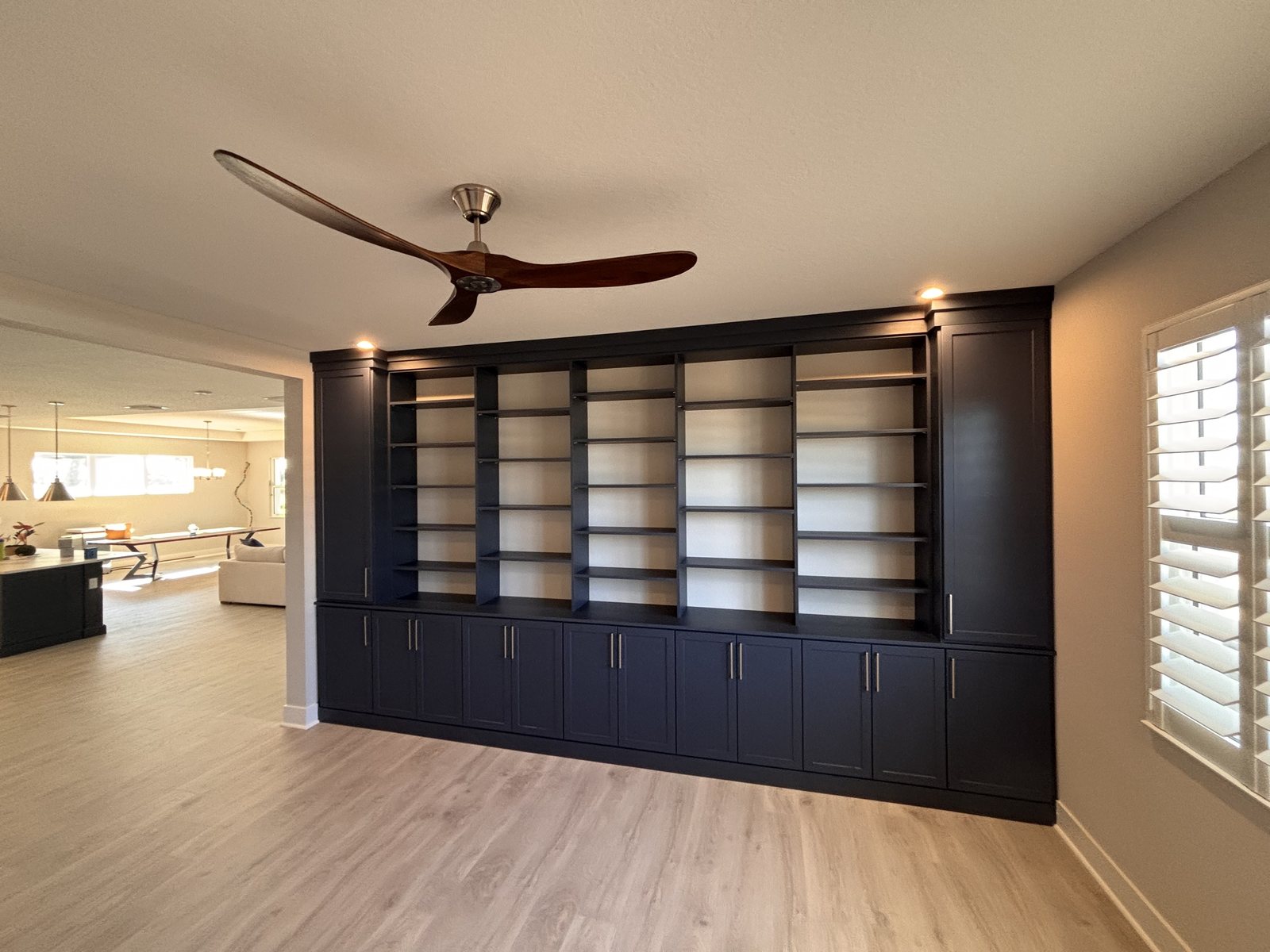 Navy built-in bookcase and cabinet wall in a home office