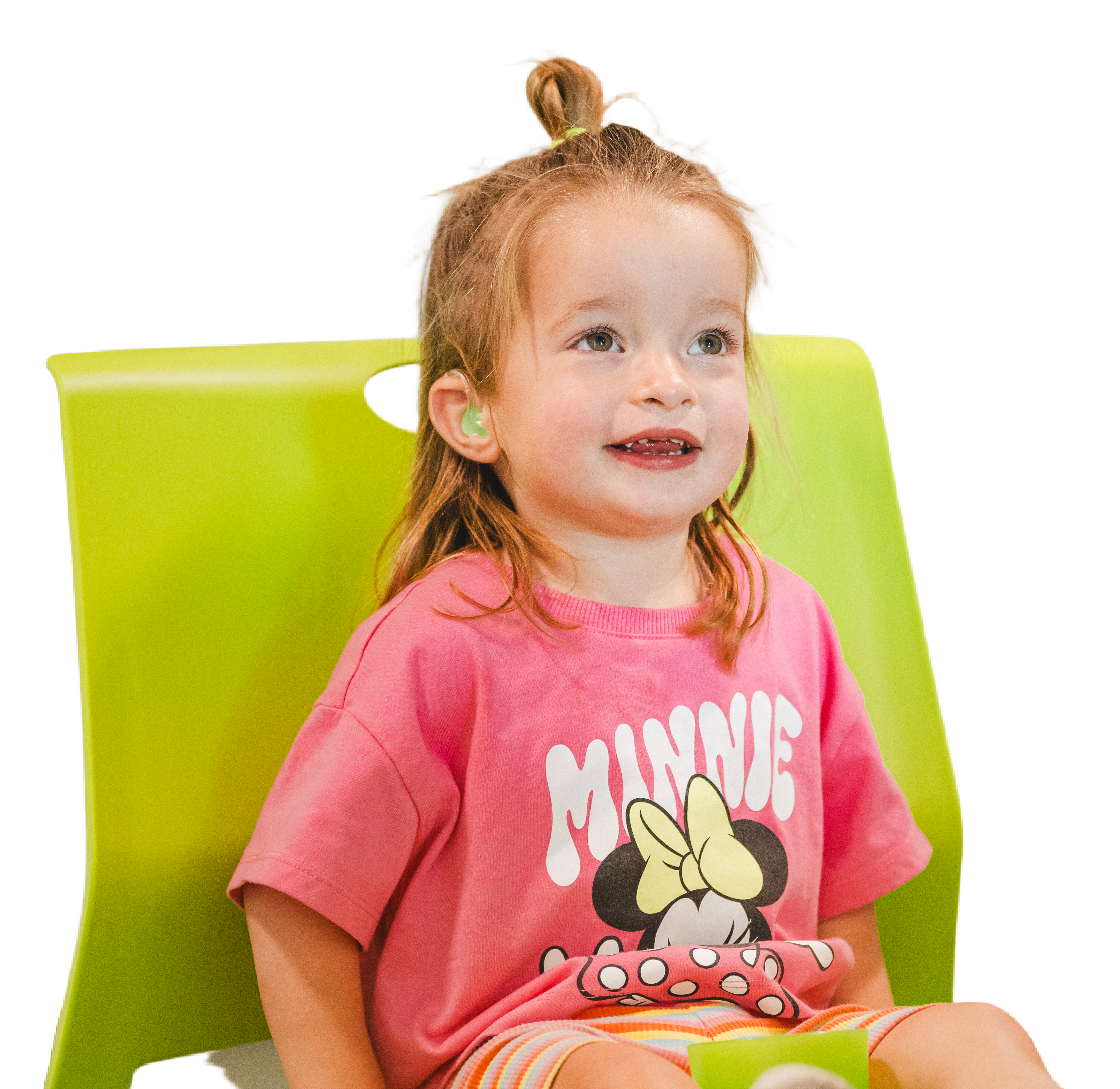 Smiling young girl wearing hearing aids during a pediatric hearing session at Desert Voices Audiology — promoting early hearing and speech development. Children Pediatric Audiology in Phoenix.
