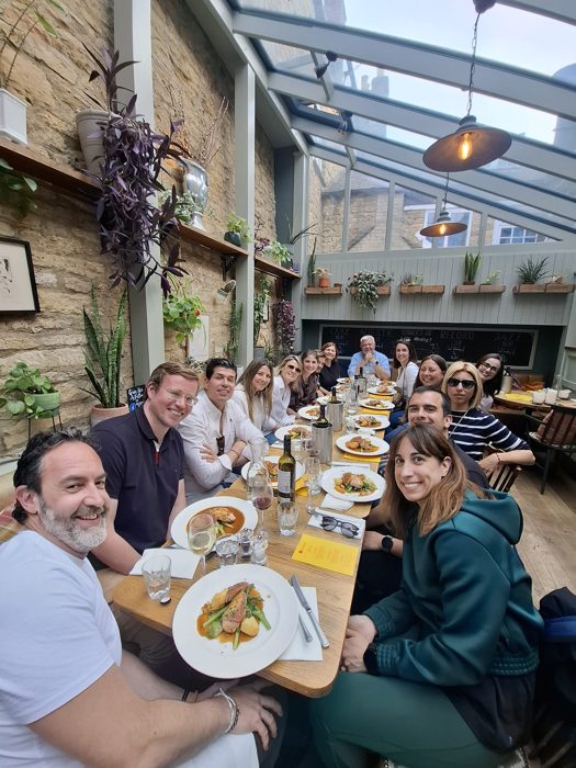 Savvy English group at dinner in a Cotswolds conservatory restaurant