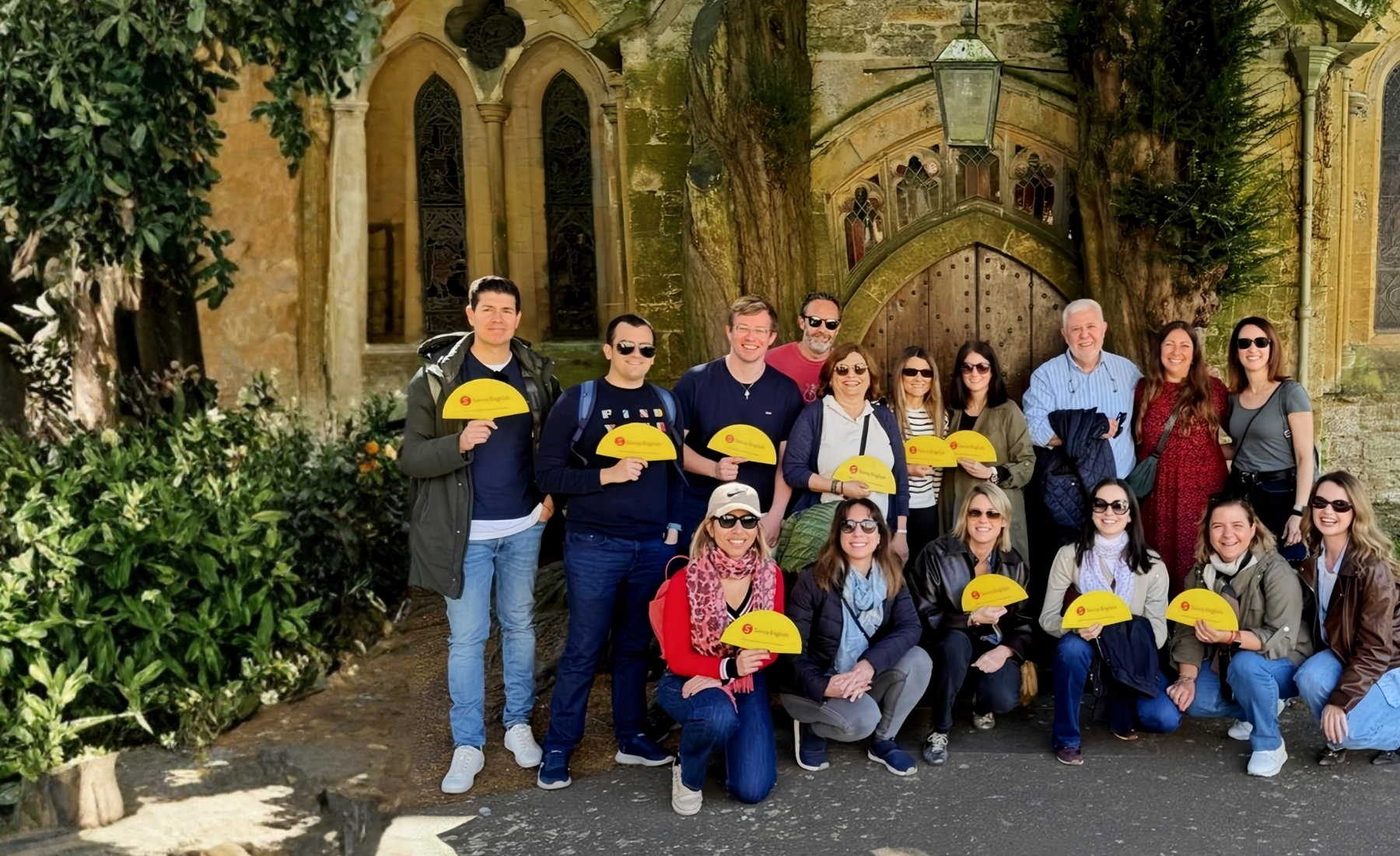 Savvy English group, mixed team, at a Cotswolds church archway during the immersion