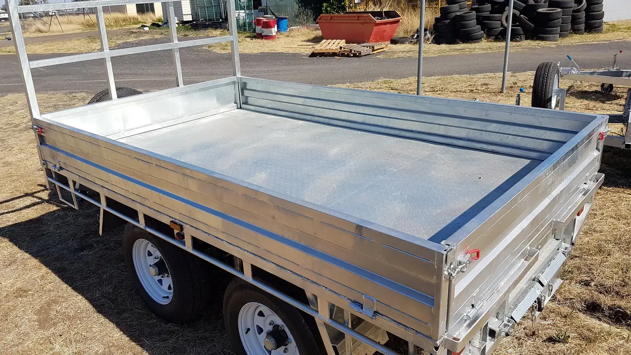 Galvanised tandem flat top trailer with a headboard in a trailer yard