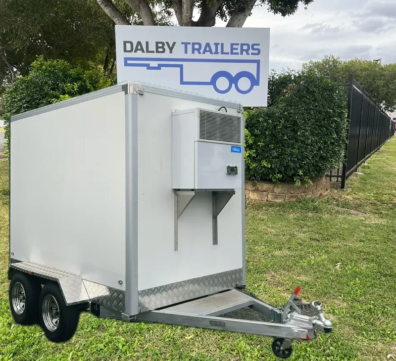 Cold room trailer parked beside a Dalby Trailers sign