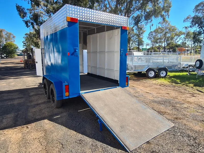 Blue and white 12x6 enclosed trailer with ramp down