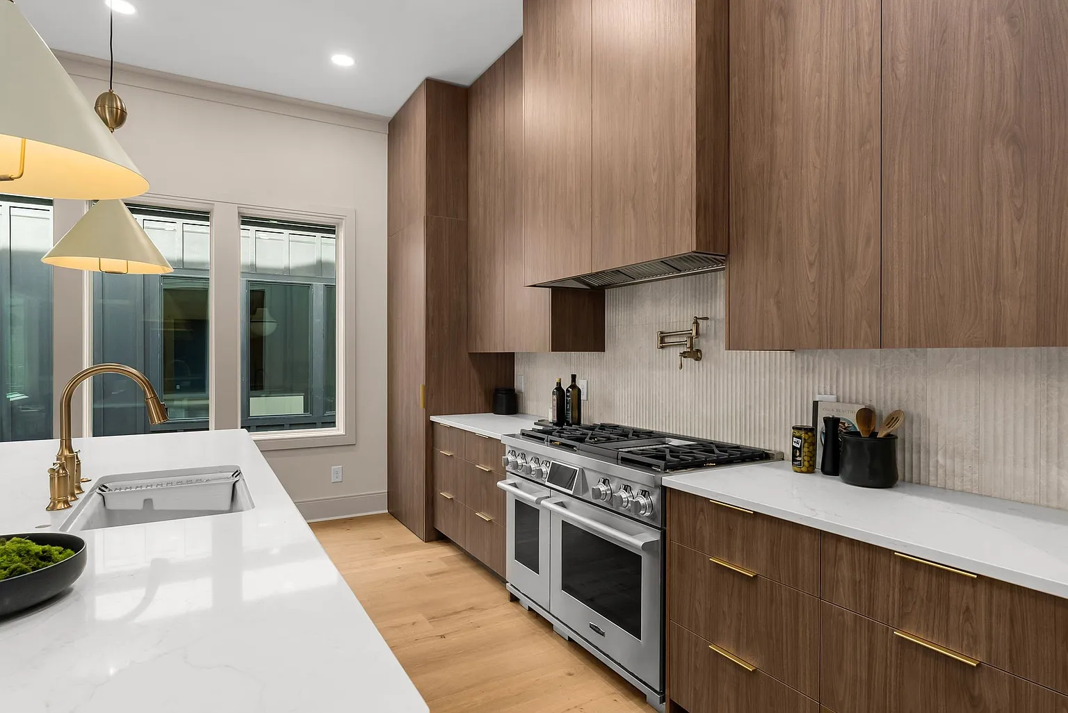 High-end kitchen with professional appliances and custom backsplash