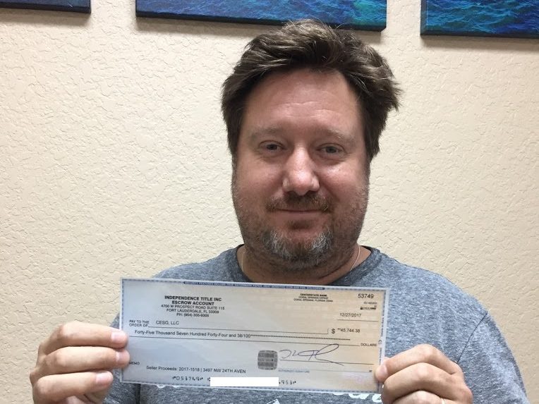Chris holding his wholesale profit check