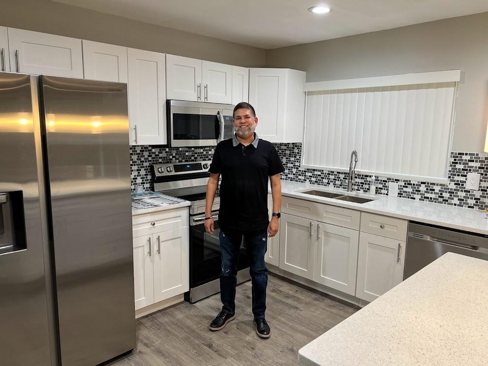 Ansar in the renovated kitchen of his first flip