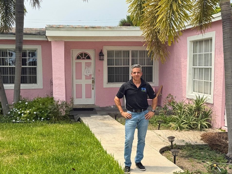 Juan in front of the first house he flipped