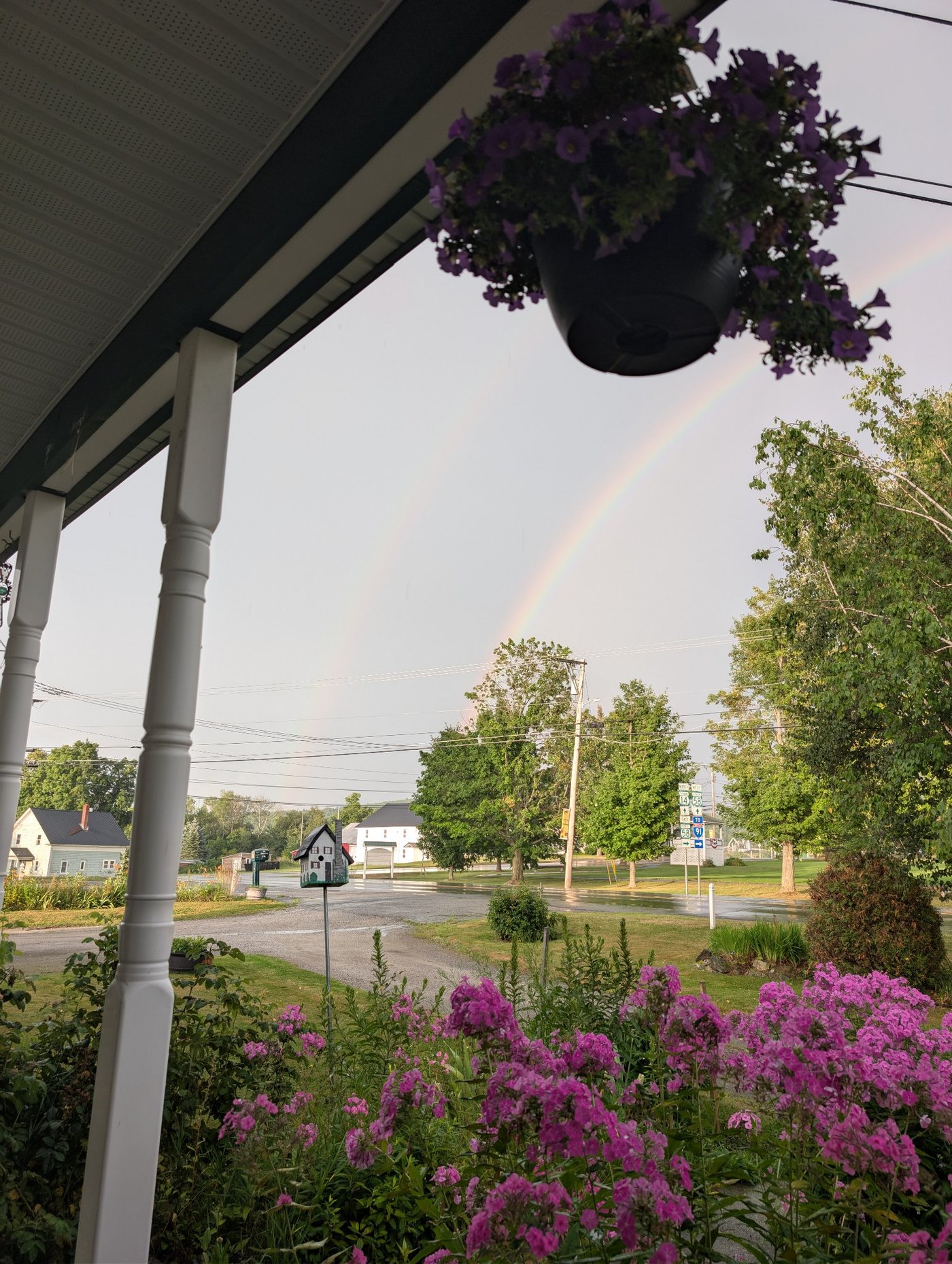 A Vermont porch under a rainbow, representing always-on AI receptionist service