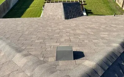 New shingle roof in Round Rock, TX with centered vent and freshly installed ridge line