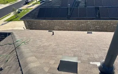 Roof inspection in Round Rock, TX showing rooftop vents, pipes, and sunlit shingles