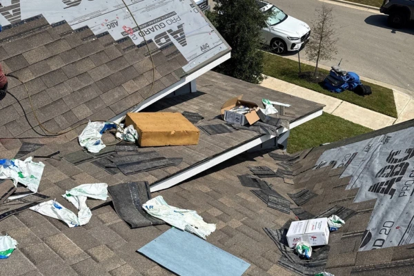 Roof shingle installation in progress with ABC Pro Guard 20 underlayment on a residential home.