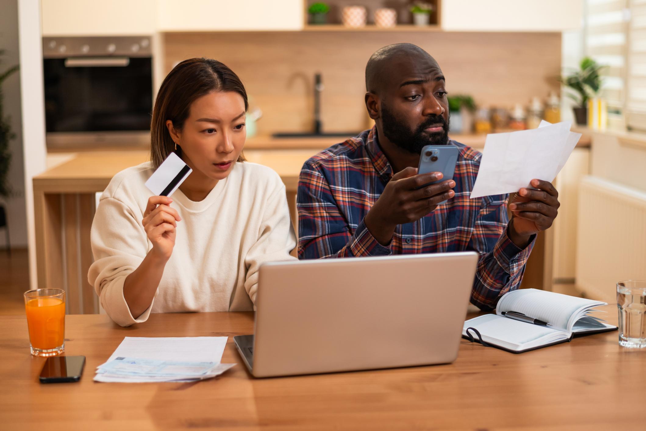 Couple reviewing bills before borrowing against home equity