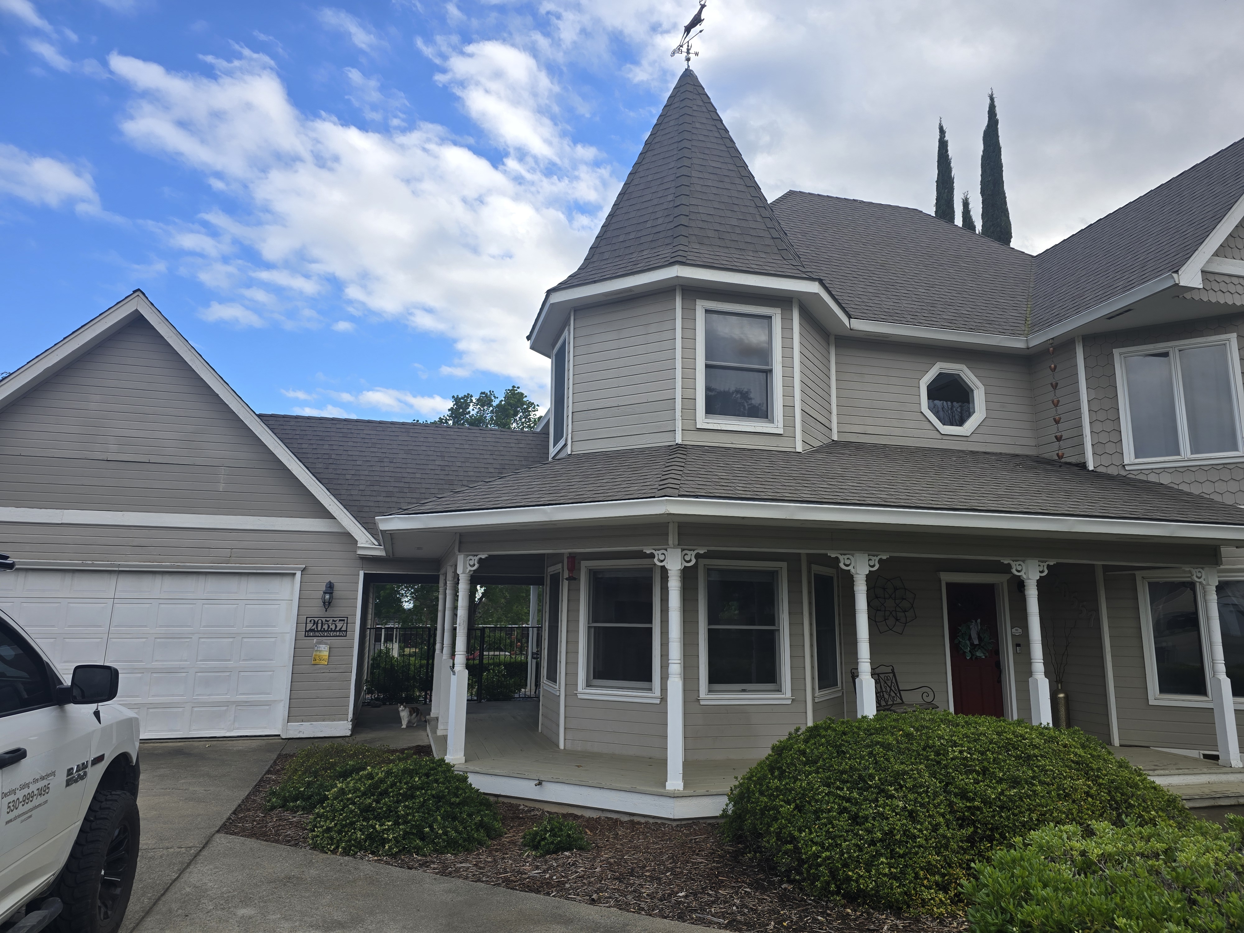 A finished O’Brien exterior: lap siding and a wraparound porch.