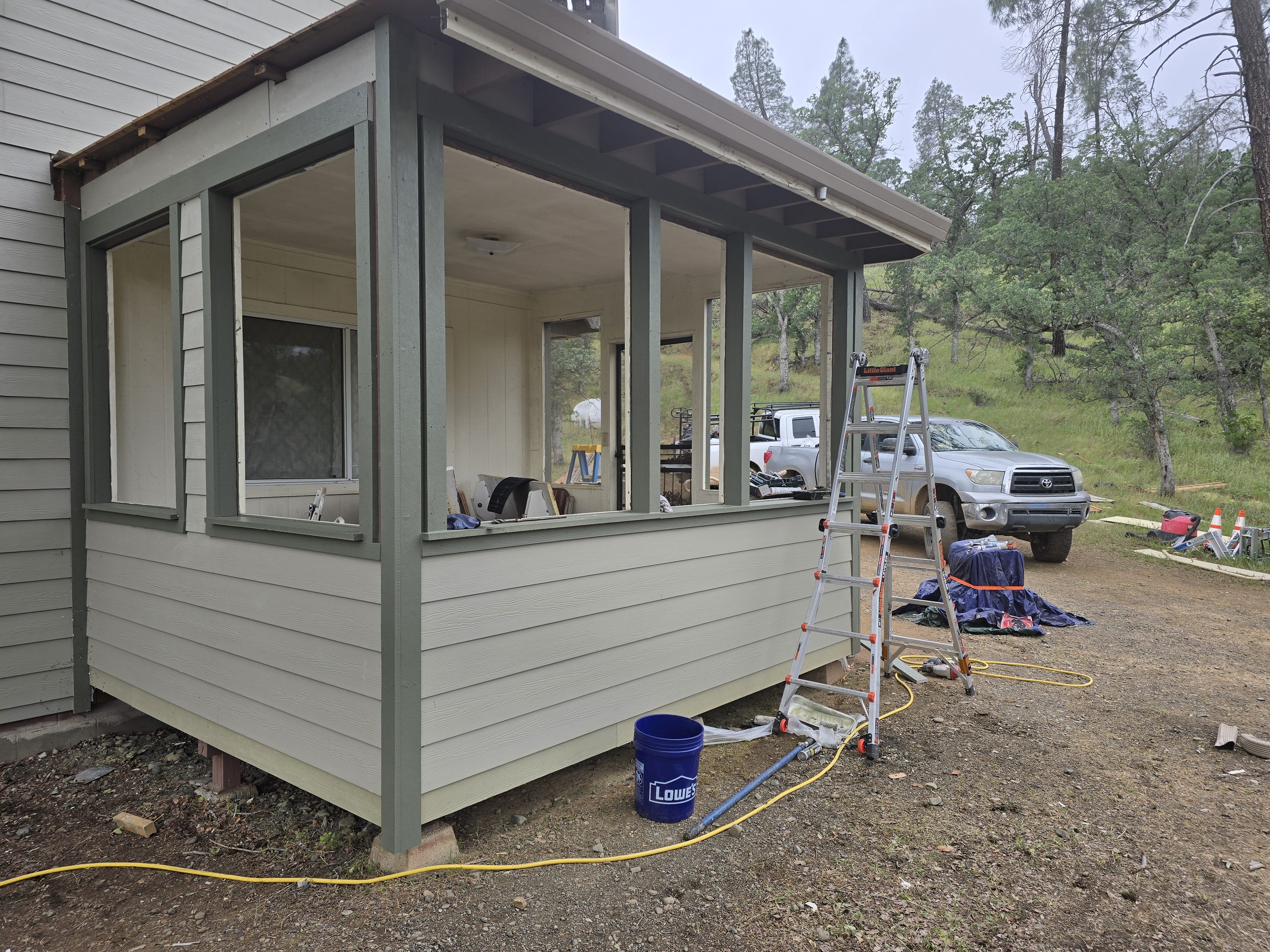 An O’Brien lap siding job in progress, with the crew’s ladder and truck on site.