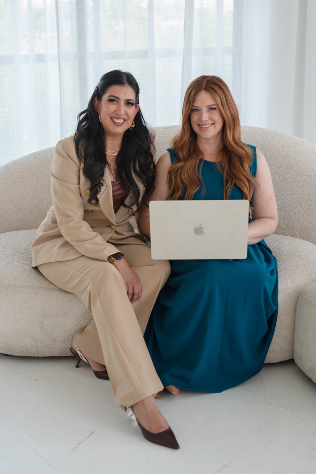 Cactus Blossom Advisory founders Jessica Prather and Marilyn Fitzpatrick working together on a laptop