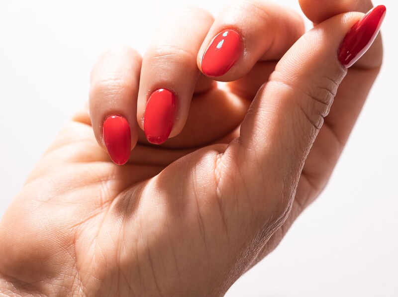 An elegant red manicure after treatment at JO Beauty Studio