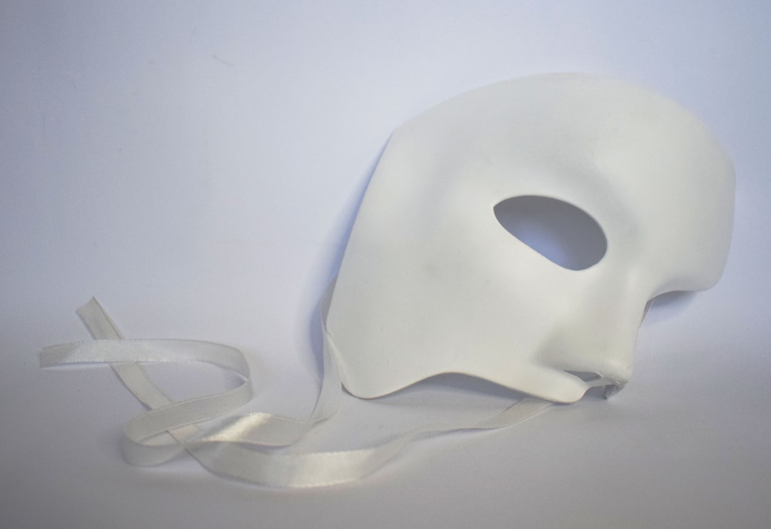 white theatre mask on silk material