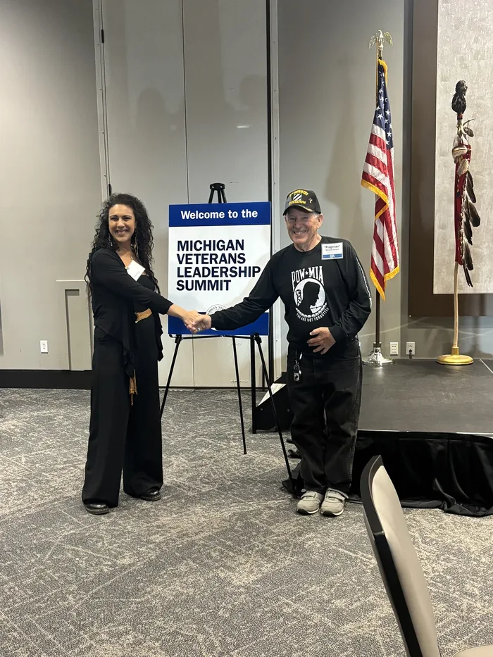 Suhey Fisher shaking hands with a veteran at the 2024 Michigan Veterans Leadership Summit