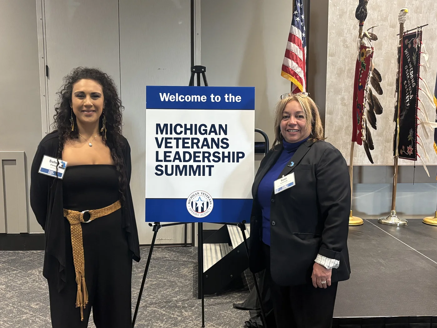 Suhey Fisher beside the welcome sign at the 2024 Michigan Veterans Leadership Summit