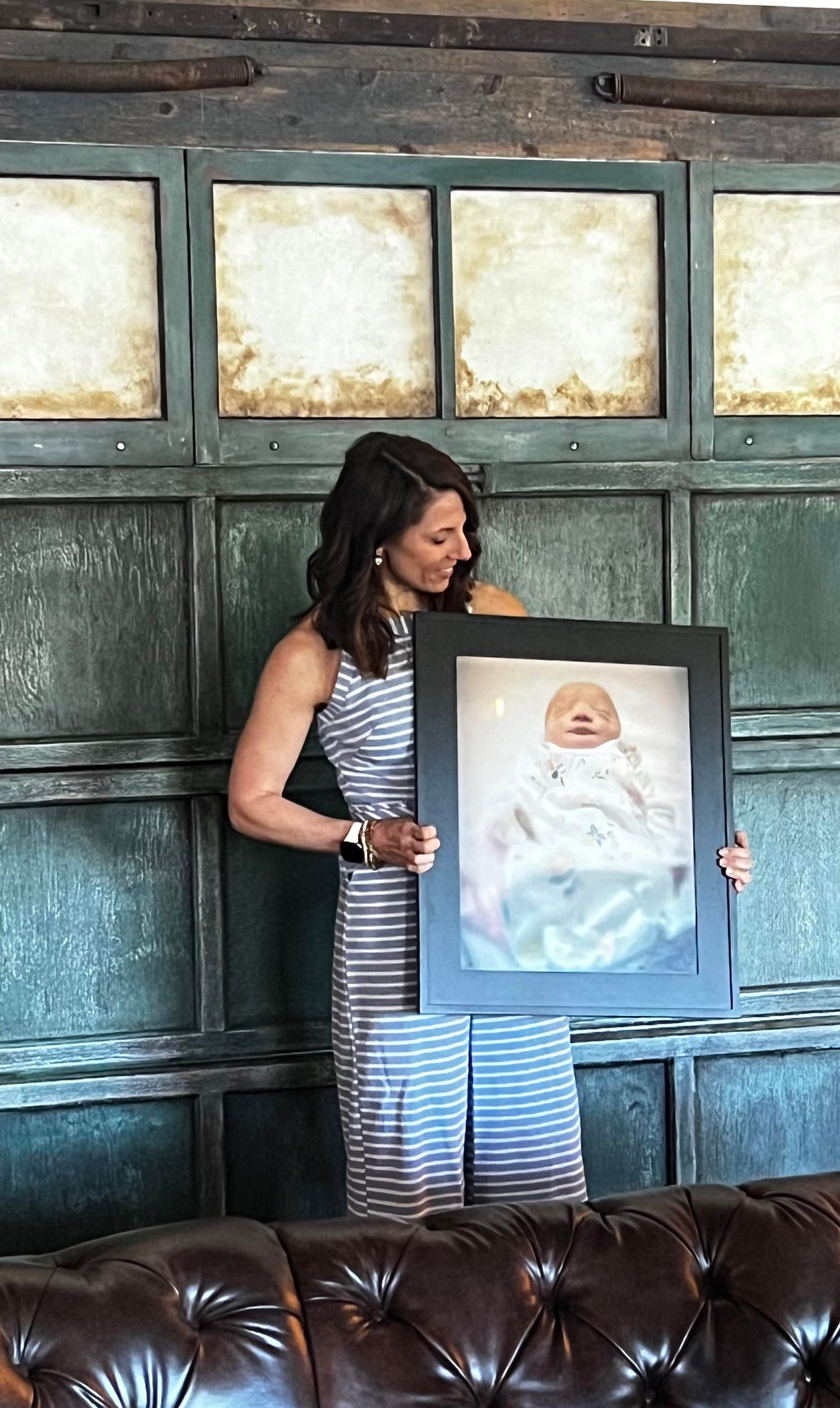 Lisa Price of Bereaved Together holding a photo of daughter Ari