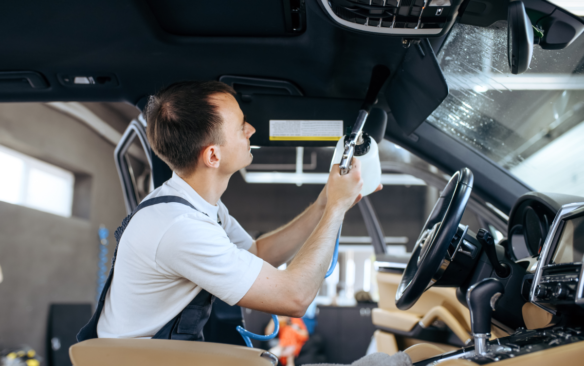 a man cleaning the interior of a car