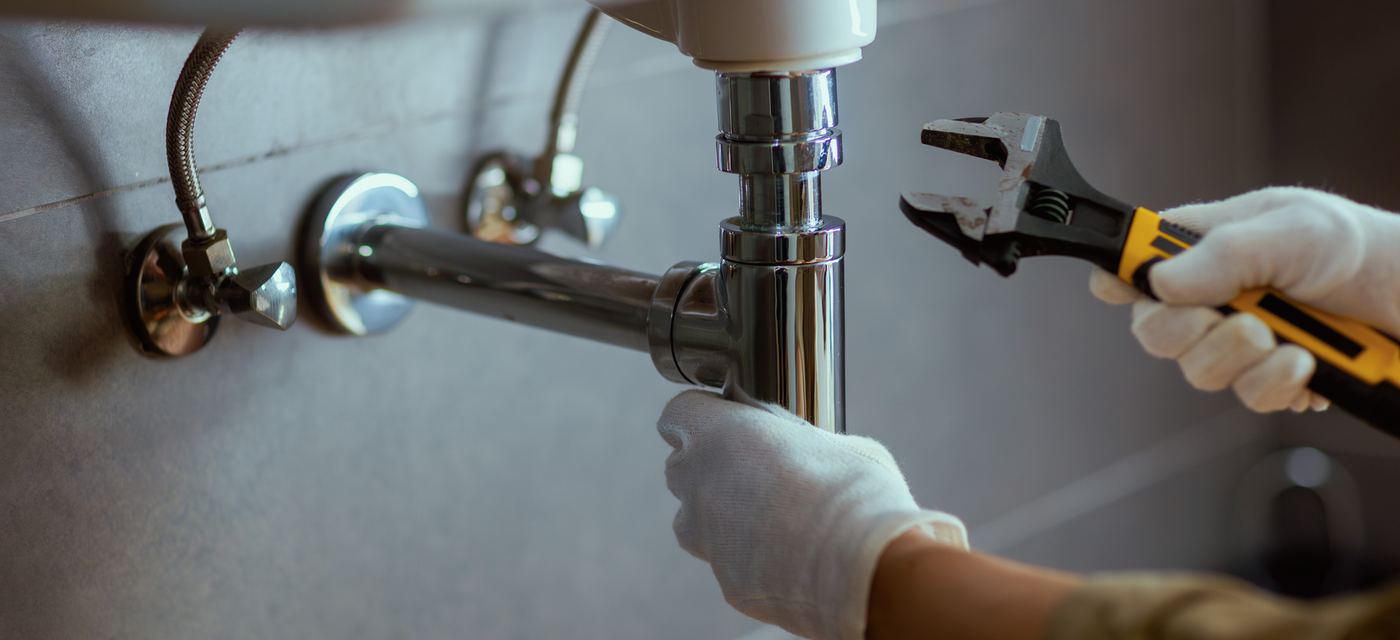 Plumber tightening a fitting