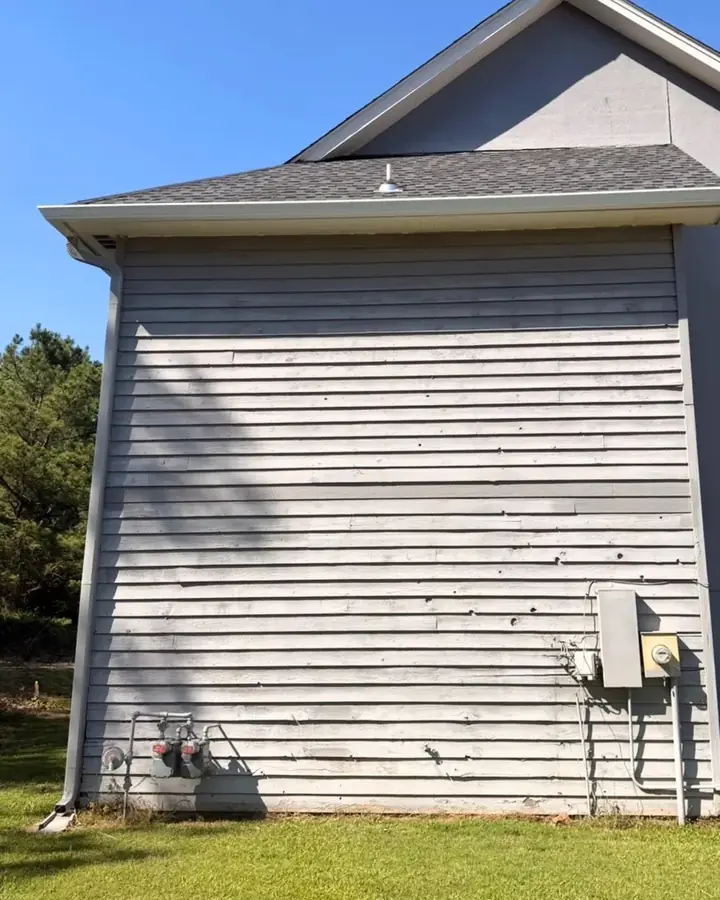Before: worn, weathered exterior wall on the side of a two-story home