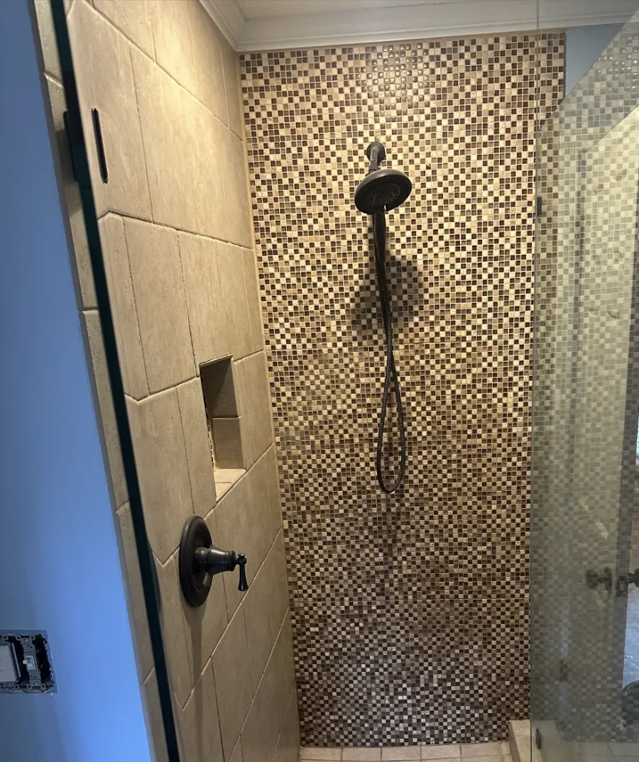 Walk-in tile shower with modern bathroom fixtures