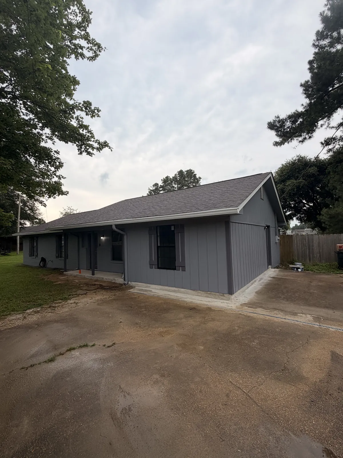 Completed home addition with gray board-and-batten siding in Columbus, Mississippi