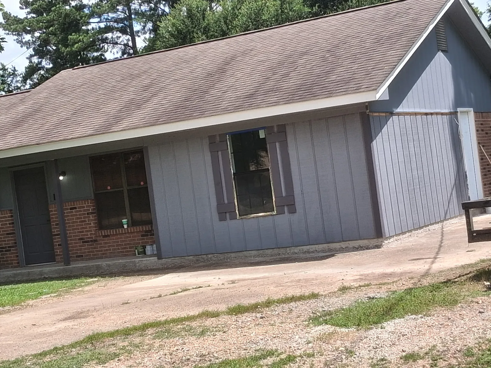 Gray vertical siding and shutters installed on the home addition exterior