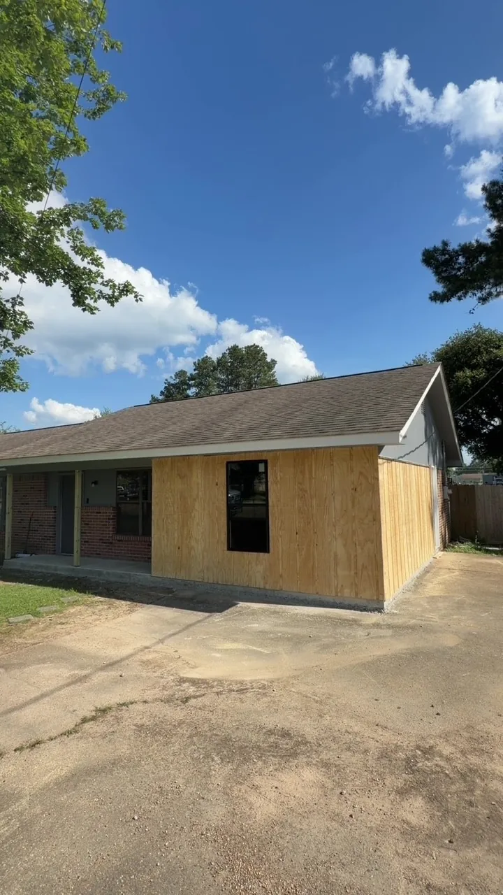 Home addition walls framed and covered in wood sheathing during construction