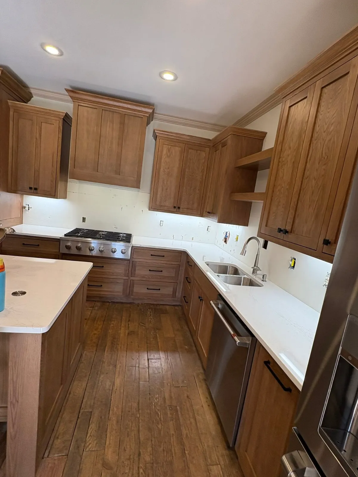 Wood kitchen cabinets and countertops installed along the walls during the kitchen remodel
