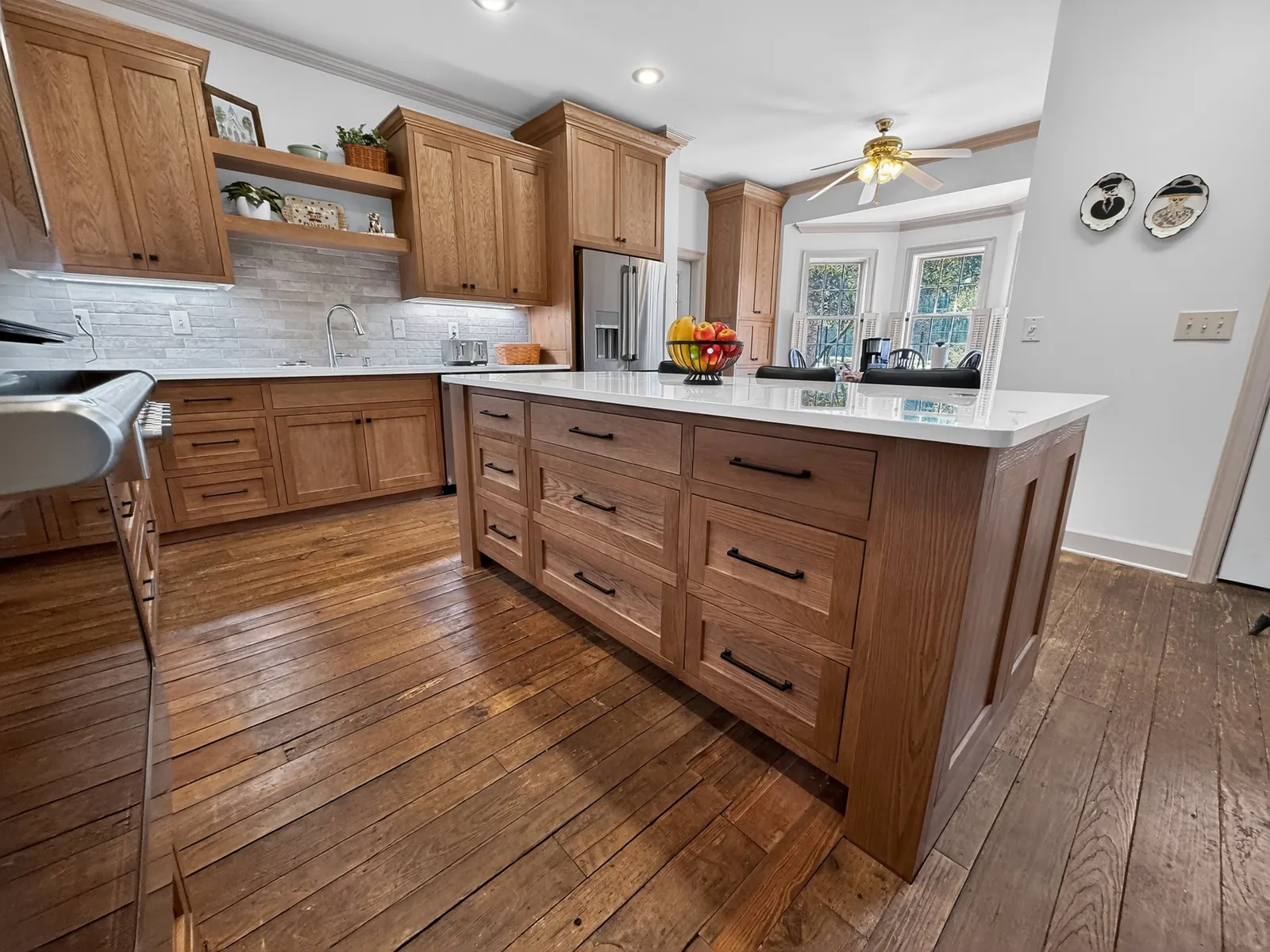 Wood kitchen island with rows of drawers and black bar pulls