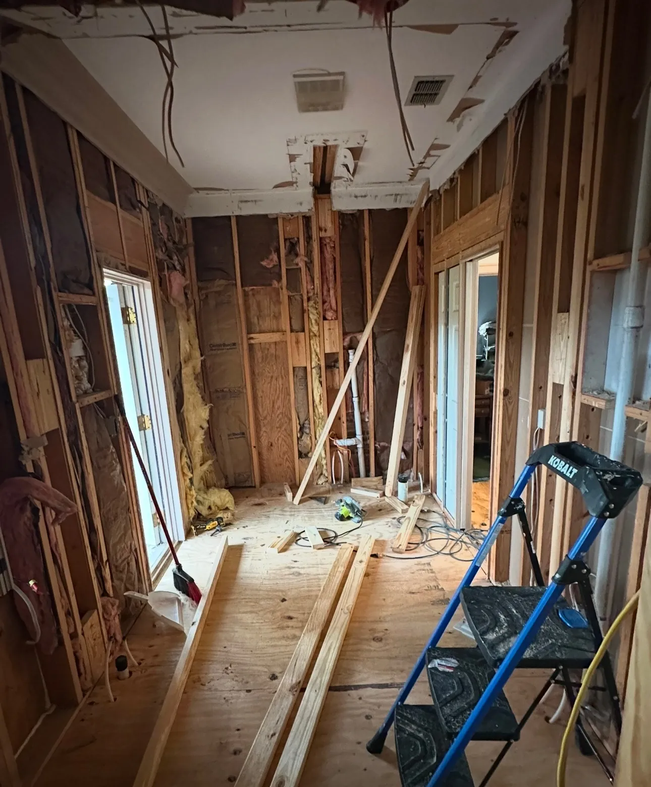 Bathroom walls and floor opened up to the wood framing during the bathroom remodel