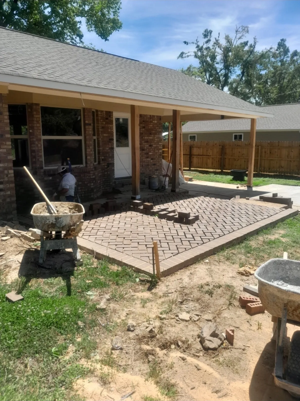 Brick paver patio in a herringbone pattern at a brick home