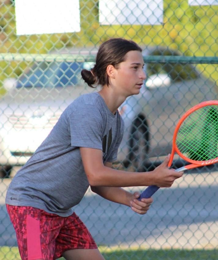 Youth tennis players practicing drills at Heroes Tennis Academy clinic